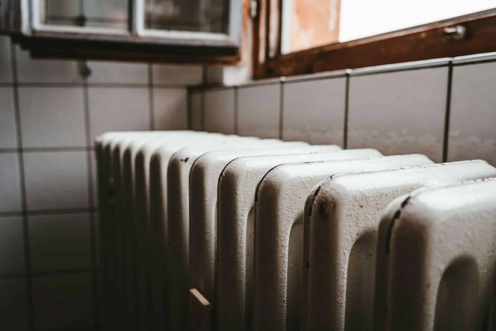 white radiator heater beside brown wooden window heating