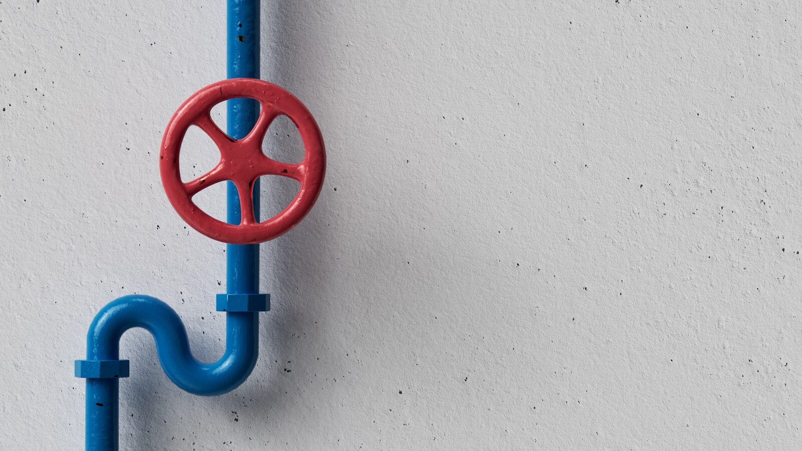 Photo by Igor Omilaev a red and blue hook on a white wall Maintenance for Industrial Pumps in Commercial Buildings in the DMV: What Facility Managers Should Know