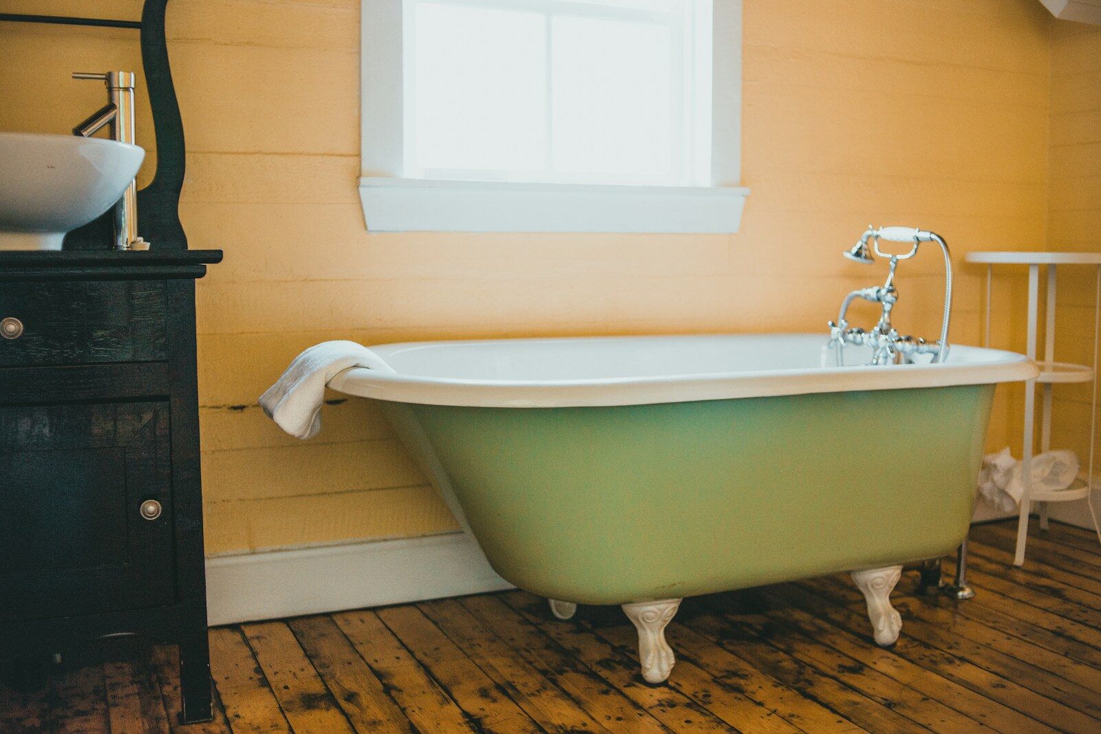 Photo by Erik Mclean white ceramic bathtub near white wall Plumber in Lanham Maryland: Reliable Service Backed by Years of Local Experience