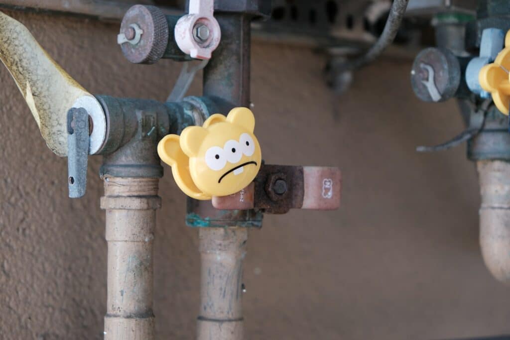 yellow and green steel pipe with yellow smiley emoji
