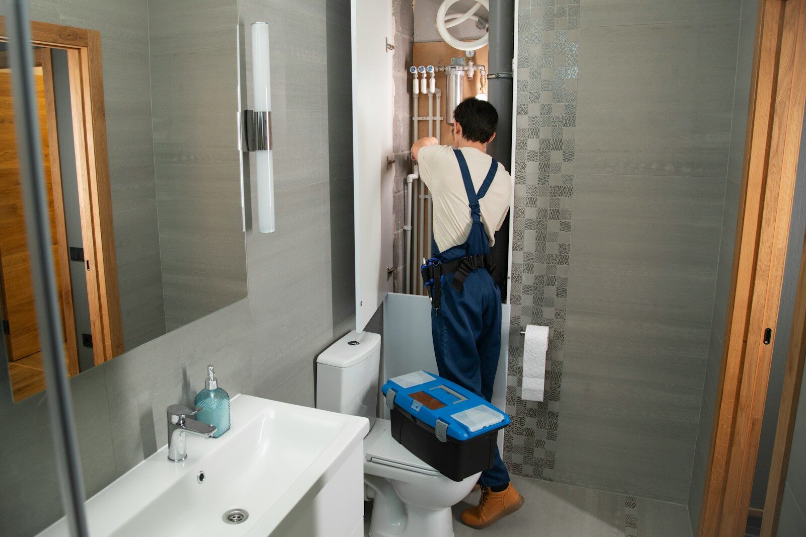 Photo by bhagya laxmi A plumber repairs plumbing in a bathroom. Plumber in Laurel Maryland: Trusted Experts for Repairs, Installations, and Maintenance