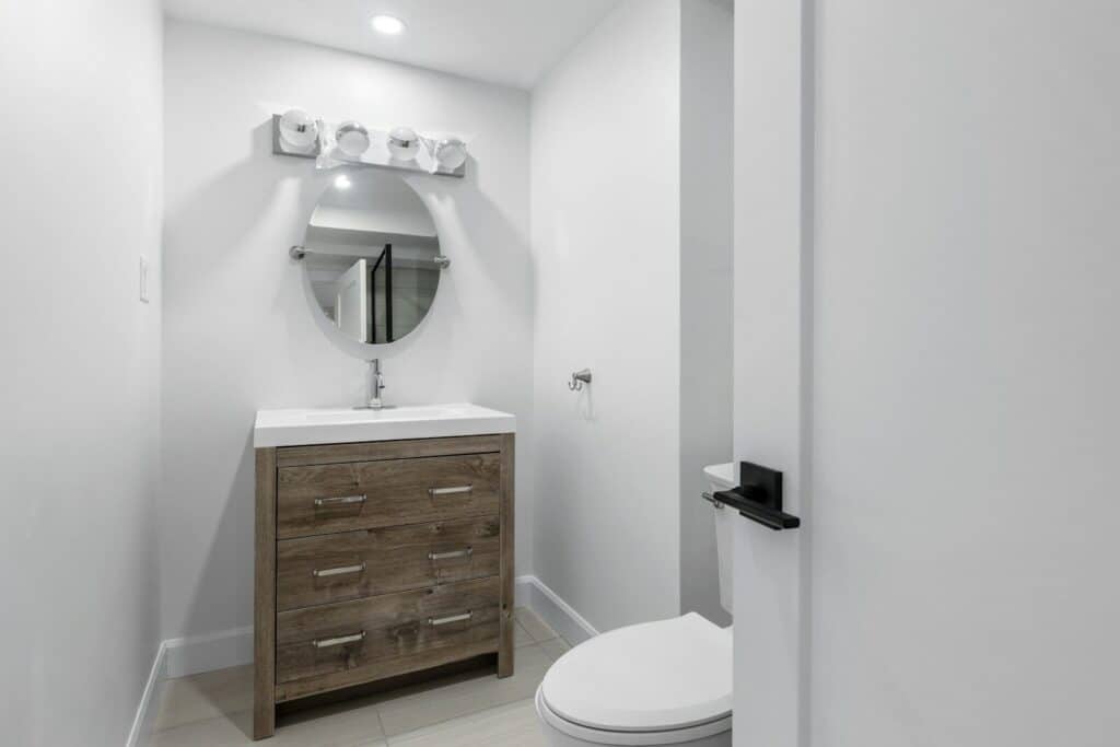 a white toilet sitting next to a bathroom sink Plumber in Washington DC: Trusted Plumbing Pros for the Capital Region