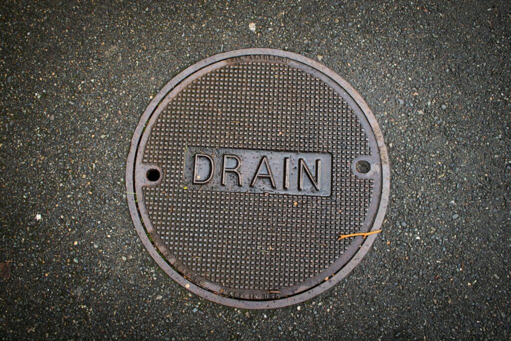 Drain cover with the word "drain" on it.
