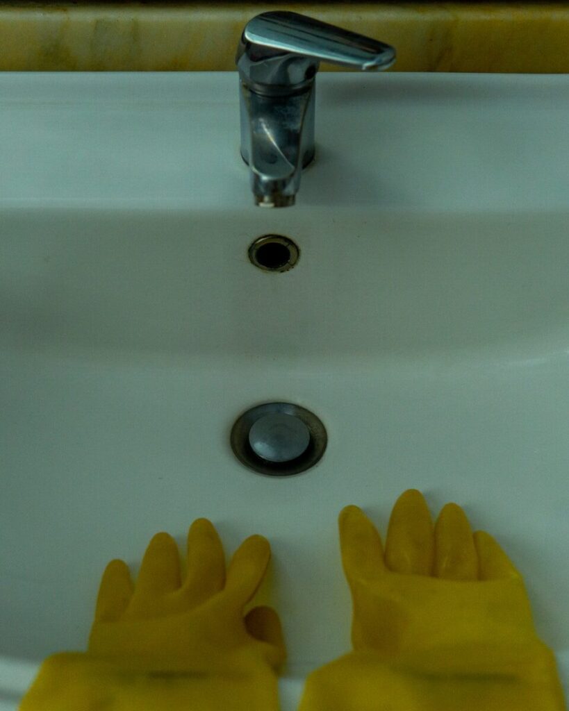 a hand reaching towards a sink